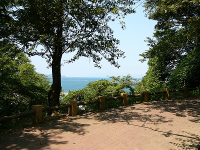 くすんだ赤いレンガの道のカーブからは、木々が途切れ海が見えた。