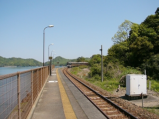 遠くの緩やかなカーブに走り去っていく気動車の快速みえ。