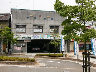 古いコンクリートでできた四角い建物。一階部はガレージになっている。