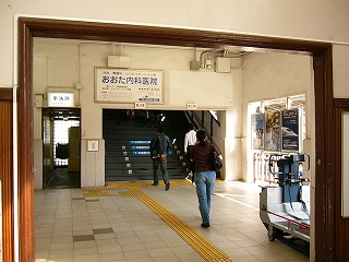 左に縦長の細いトイレへの入口。右に跨線橋への階段の大きな入口。