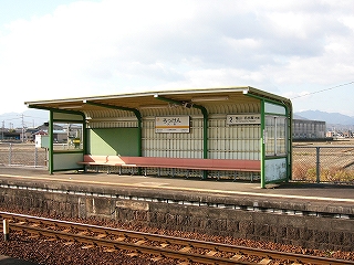 長い椅子が幅いっぱいに設置された、少し横に長い簡単な待合所。線路内に面している部分が開方式になっている。