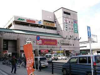 薄桃色で薄汚れた再開発ビル。