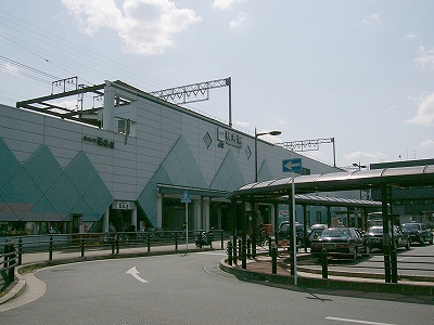 横長の駅舎を斜めに見て。タクシーのりばの細長い屋根が緩やかな曲線を描いている。