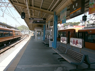 ホームの風景。V字型の上屋、長椅子。線路無いには日が差していて明るい。